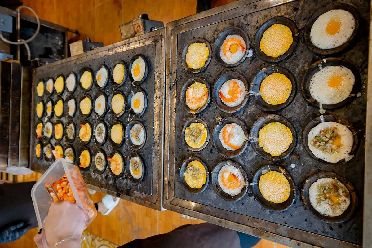 Nhân bánh căn có nhiều loại: hải sản (tôm, mực...), trứng cút, thịt bằm...