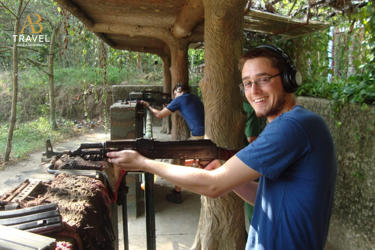 Visitor experiencing the shooting range during one of the best Cu Chi tours.